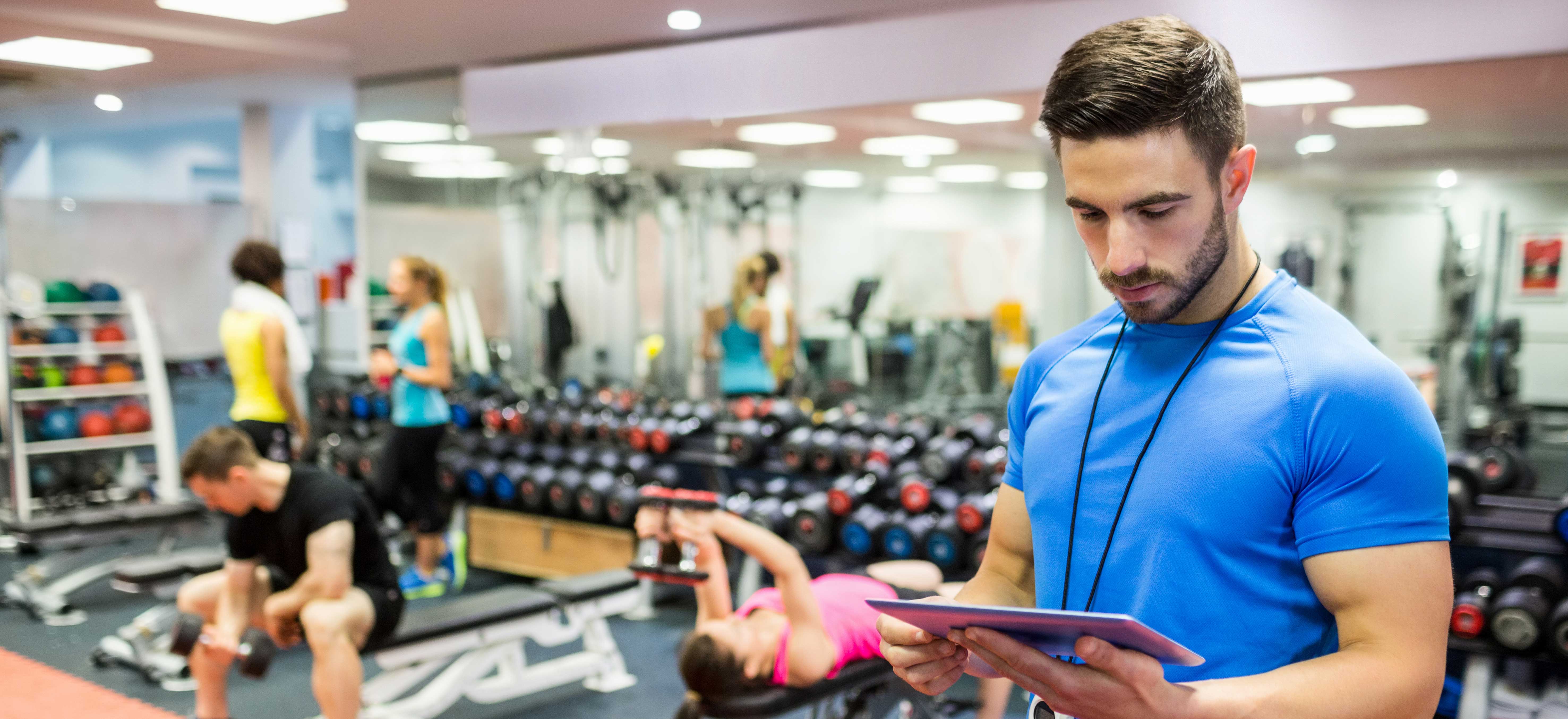 Personal trainer reading clip board