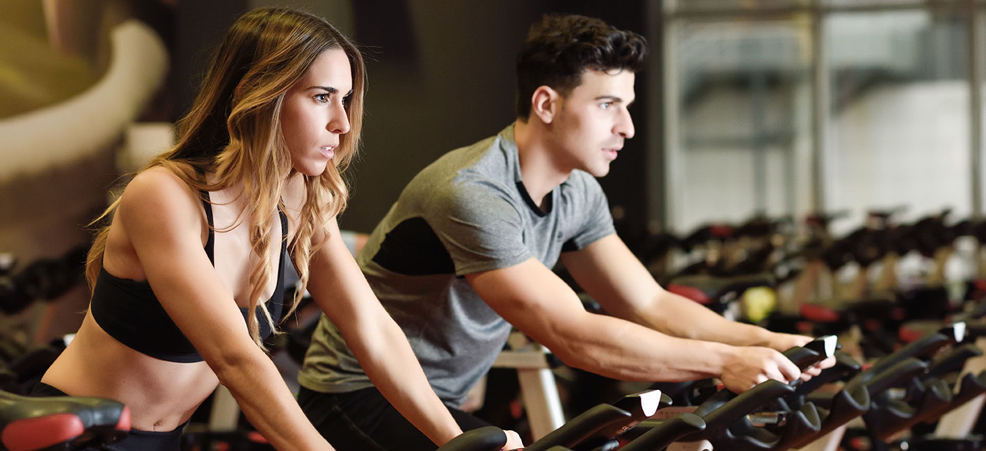 Man and woman on exercise bike